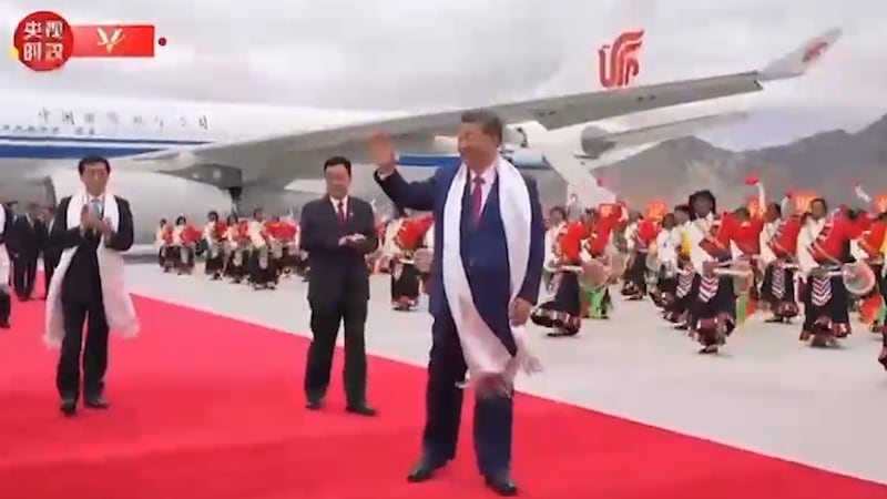 In this image made from Chinese government video, Chinese President Xi Jinping, center, waves as he is greeted upon his arrival in Lhasa, Tibet Autonomous Region, Aug. 20, 2025.
